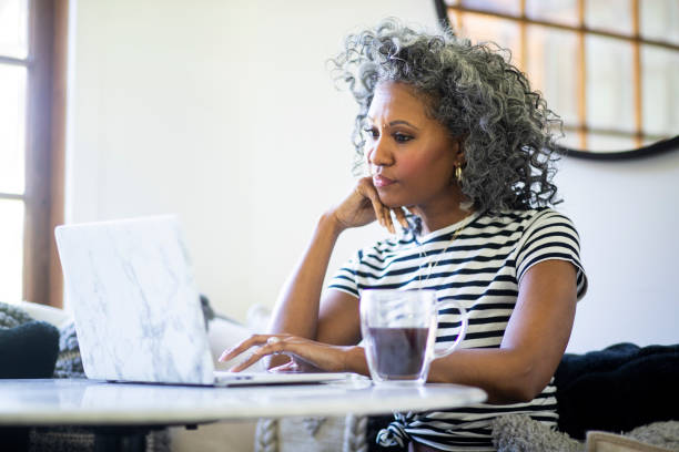 istock Beautiful Black Woman Using Laptop at Home 1136638679