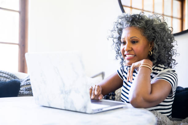 istock Beautiful Black Woman Using Laptop at Home 1136638736
