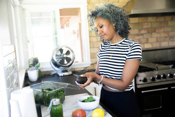 istock Black woman preparing a healthy meal 1136639077