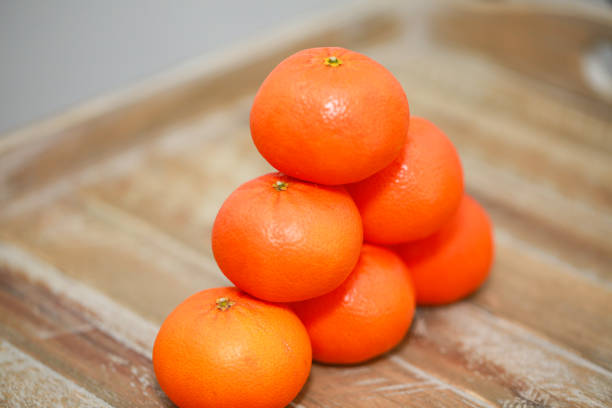 istock orange on wooden cutting board 1136639086
