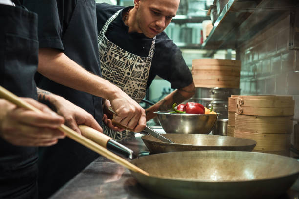 istock Everything should be perfect. Restaurant chef looking his assistants cooking a new dish in a kitchen. 1136639484