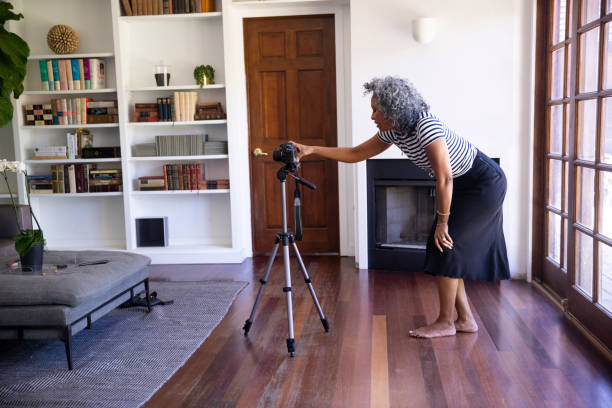 istock Black Woman Setting up Tripod and Camera to Record Vlog 1136639722