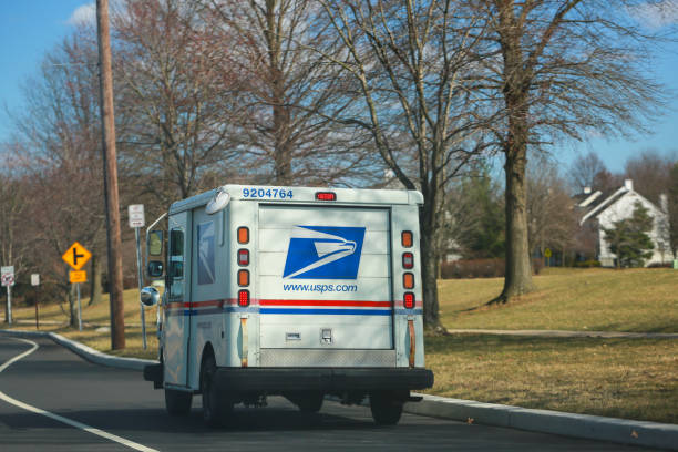 United States Postal Service collection and delivery van on a residential complex stock photo