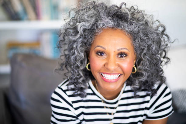 Closeup Headshot of a Beautiful Black Woman A beautiful black woman with white curly hair  smiles for a headshot actress headshot stock pictures, royalty-free photos & images
