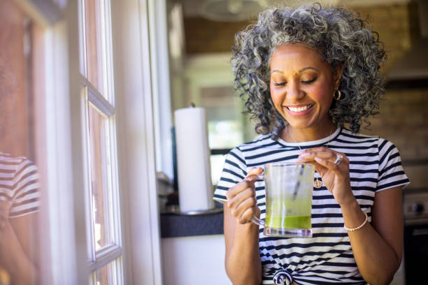 istock Mature Black Woman Drinking a Green Smoothie 1136640661
