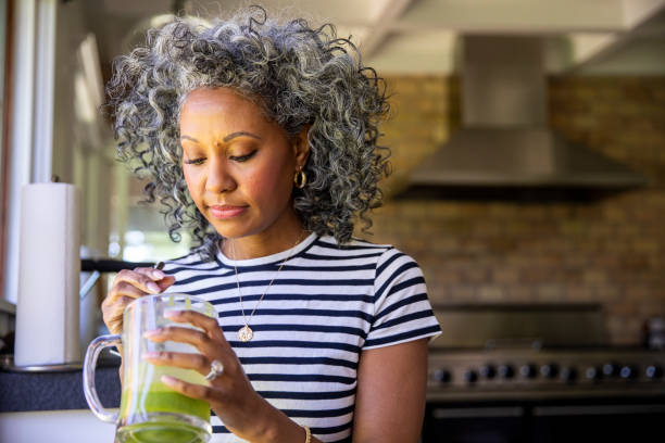 istock Mature Black Woman Drinking a Green Smoothie 1136640725