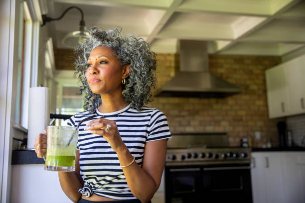 istock Mature Black Woman Drinking a Green Smoothie 1136640778