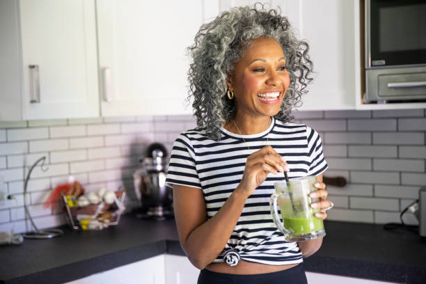istock Mature Black Woman Drinking a Green Smoothie 1136640820