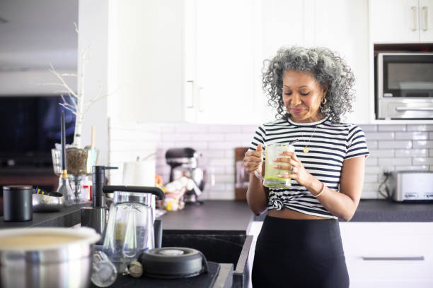 istock Mature Black Woman Drinking a Green Smoothie 1136640846