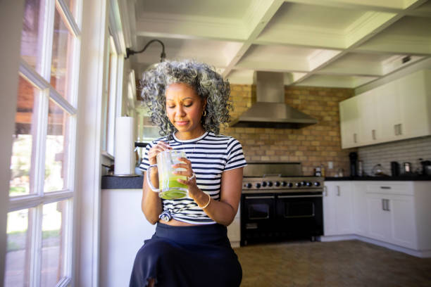 istock Mature Black Woman Drinking a Green Smoothie 1136640887