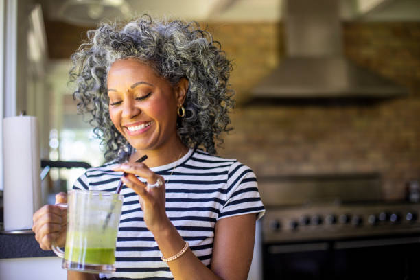 istock Mature Black Woman Drinking a Green Smoothie 1136640936