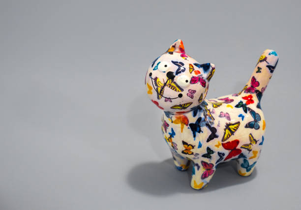 istock Ceramic colourful cat, piggy bank with soft grey background. 1136641501