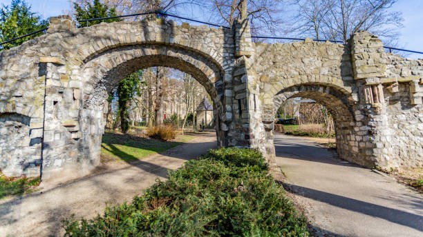 istock Two footpaths with an old stone bridge with two arches in the Proosdij park 1136642069