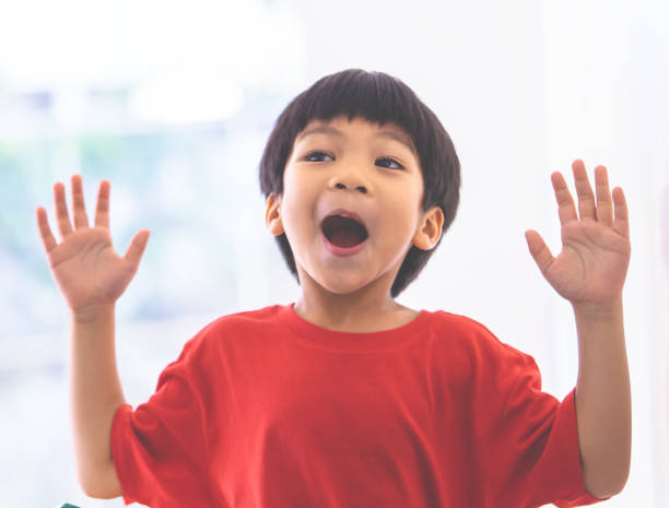istock Funny boy in hand up and screaming at camera and shocked. 1136642095