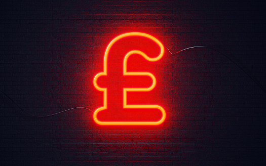 British pound symbol shaped red neon light on black wall. Horizontal composition with copy space. Great use for currency exchange concepts.