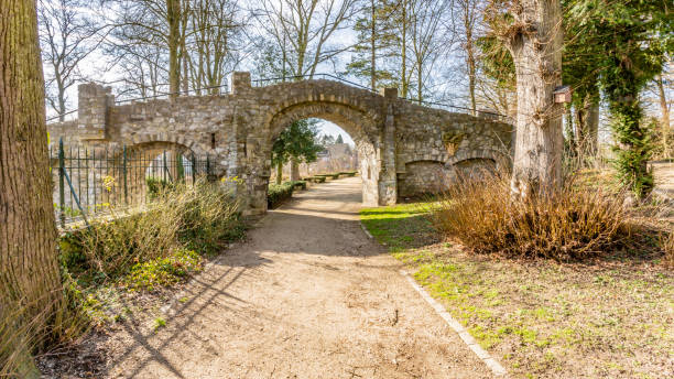 istock Old stone bridge with a dirt road in the Proosdij park 1136642488