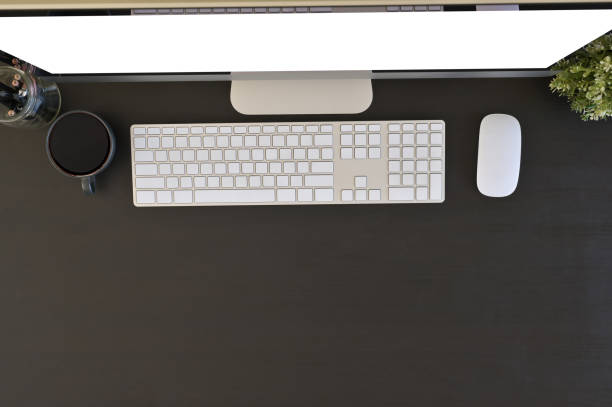 istock Office desk top view computer and office supplies above of black table. 1136642692