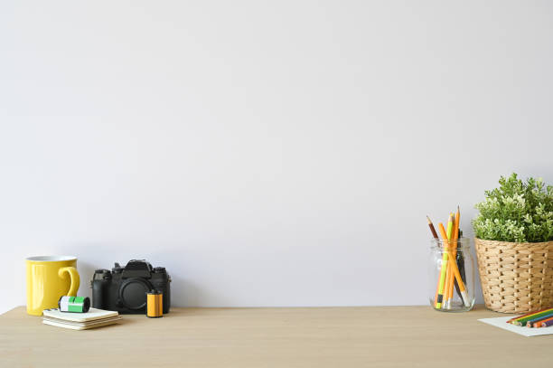 istock Creative workspace camera and office supplies on wood desk with copy space. 1136642729