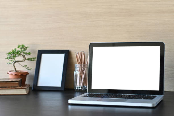istock Workspace mockup laptop computer and office supply on office desk and wooden wall. 1136642751