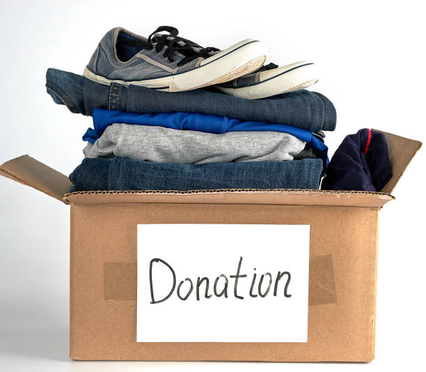 istock folded clothes and shoes in a brown paper box 1136642826