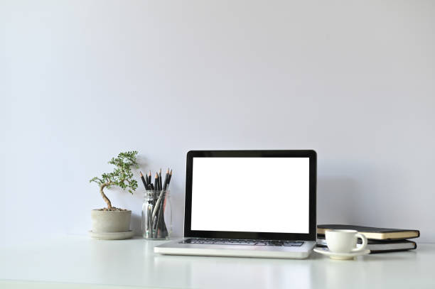 istock Mockup laptop computer and office supplies and small bonsai on workspace. 1136642831