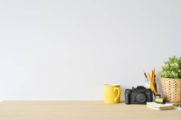 istock Creative workspace camera and office supplies on wood desk with copy space. 1136642857