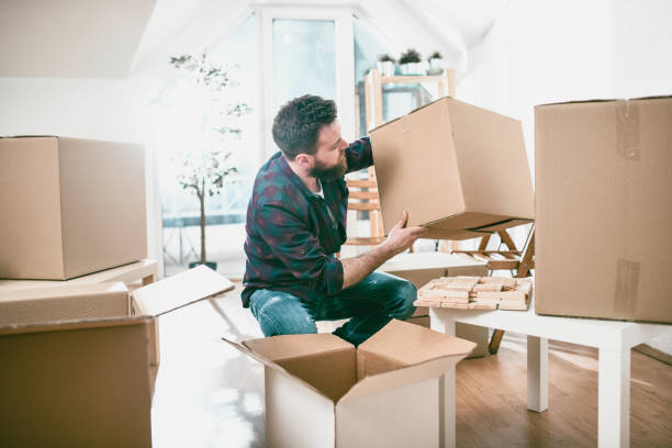 istock Handsome Male Unpacking In New Home 1136644067