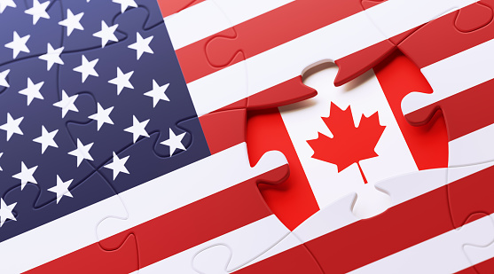American and Canadian flag puzzle. Horizontal composition with copy space and selective focus.