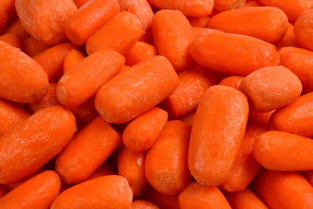 istock Little fresh carrots as a background. Snack. 1136644784