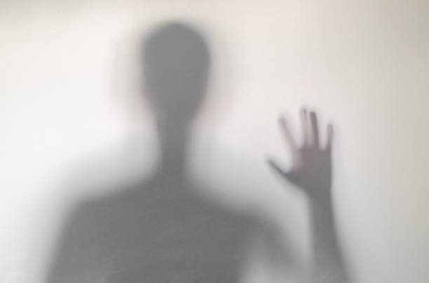istock Man waving or rising his hand behind curtain. 1136645974
