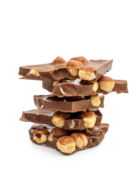 istock Pieces of chocolate with whole nuts on white. 1136646835