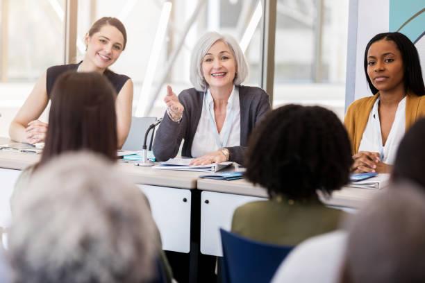 istock Mature businesswoman talks during panel discussion 1136648321