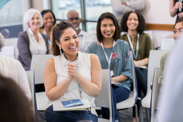 Happy woman applauds during seminar