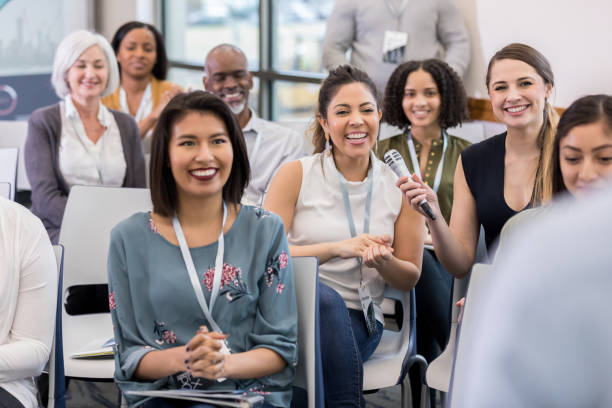 istock Happy woman asks question at business conference 1136648334