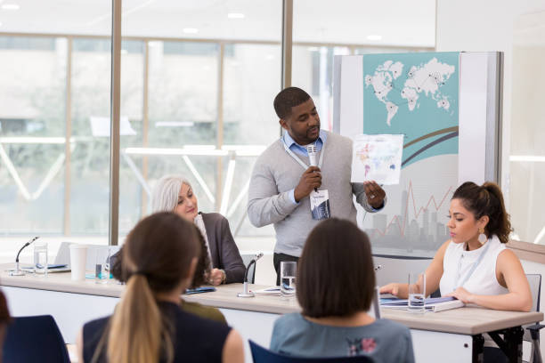 istock Mid adult businessman discusses something during conference 1136648341