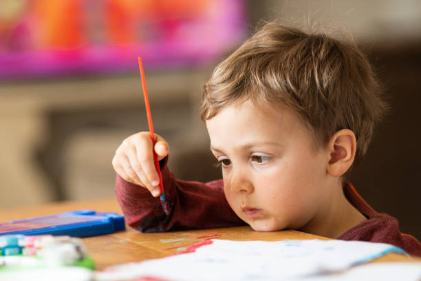 istock Three years old child painting with watercolors 1136648350