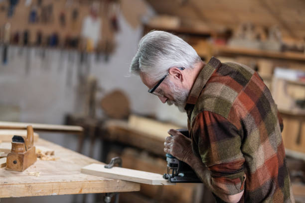 istock Senior Carpenter Working In His Old-Fashion Workshop 1136649394
