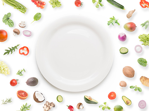 Vegetables and fruits with plate on white background.