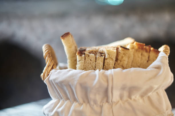 Close-Up Of Beautiful Wicker Bread Basket With Sliced Bread At Sunset