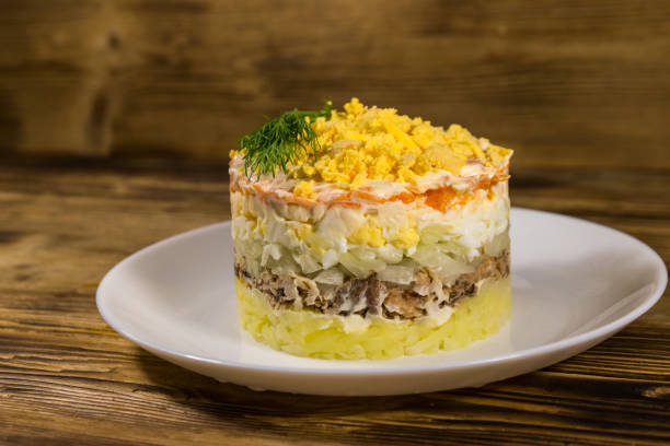 istock Traditional russian salad Mimosa on wooden table 1136651509