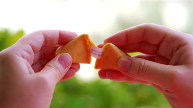 Opening chinese fortune cookie with a card inside in slow motion 180fps