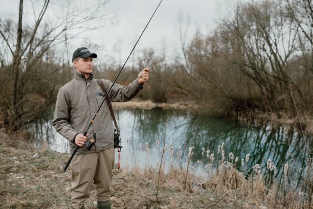 istock Young man is fishing 1136654524