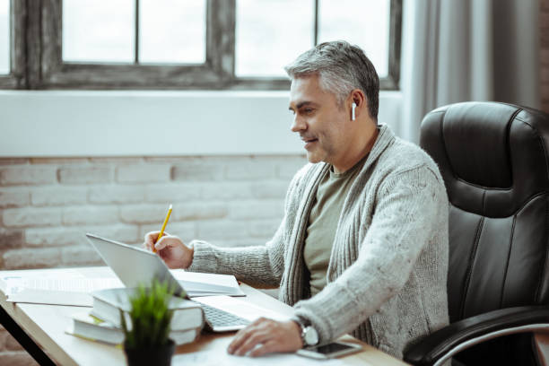 Positive happy man looking at the laptop screen