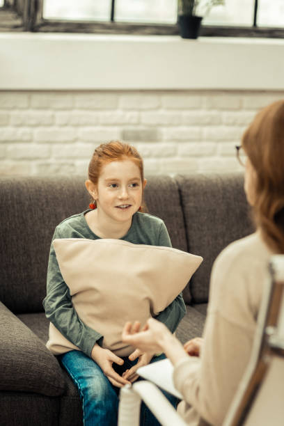 istock Pleasant nice girl sitting with a cushion 1136654812