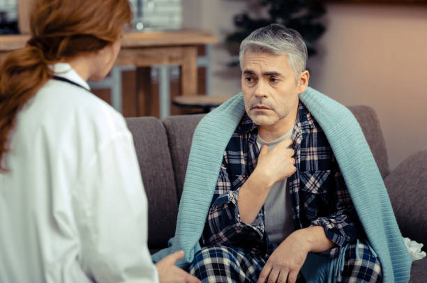 istock Depressed ill man sitting opposite his doctor 1136655101