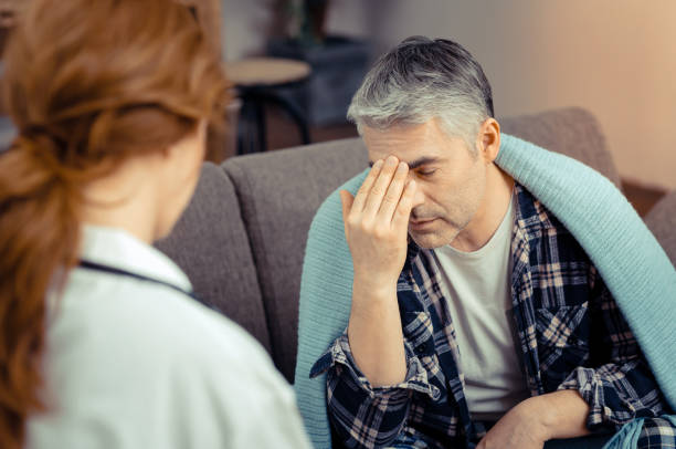 istock Depressed ill man touching the forehead with his hand 1136655124