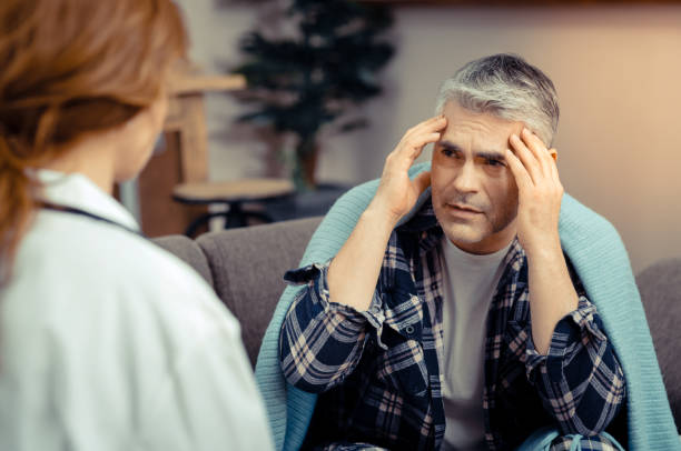 istock Sad gloomy mature man holding his temples 1136655141