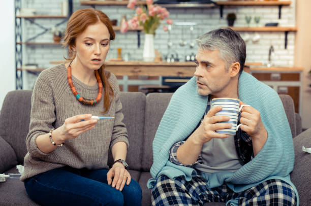 istock Nice ill man sitting with a cup of tea 1136655148