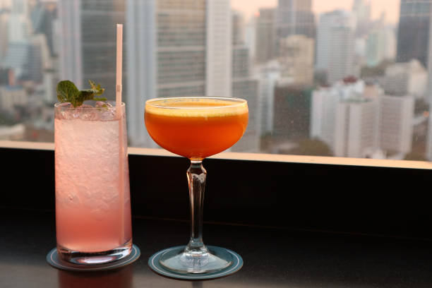 istock Two different type of cocktails on the rooftop bar with blurry skyscrapers view in backdrop 1136655404