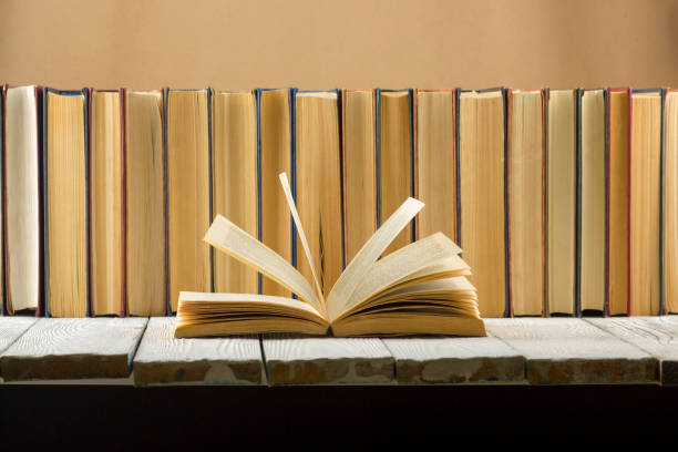 istock Open book, hardback books on wooden table. Back to school. Copy space. 1136656077